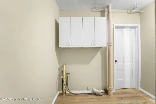 a view of a hallway with wooden floor and a hallway