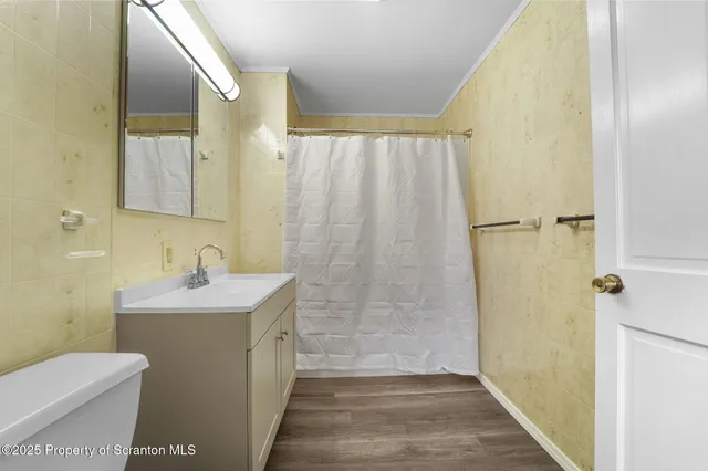 a white toilet sitting next to a bathroom sink