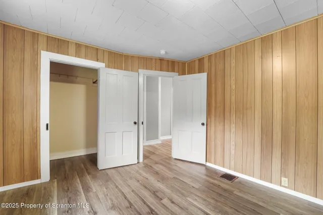 a view of a room with a wooden door