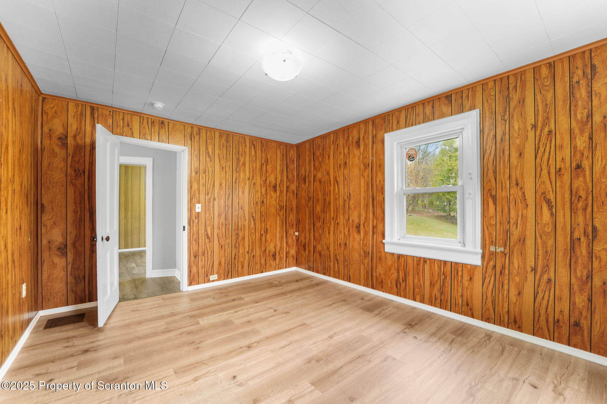 117 Church Road Harford, PA 18823 - Photo 27 of 35 a view of an empty room with wooden floor and a window