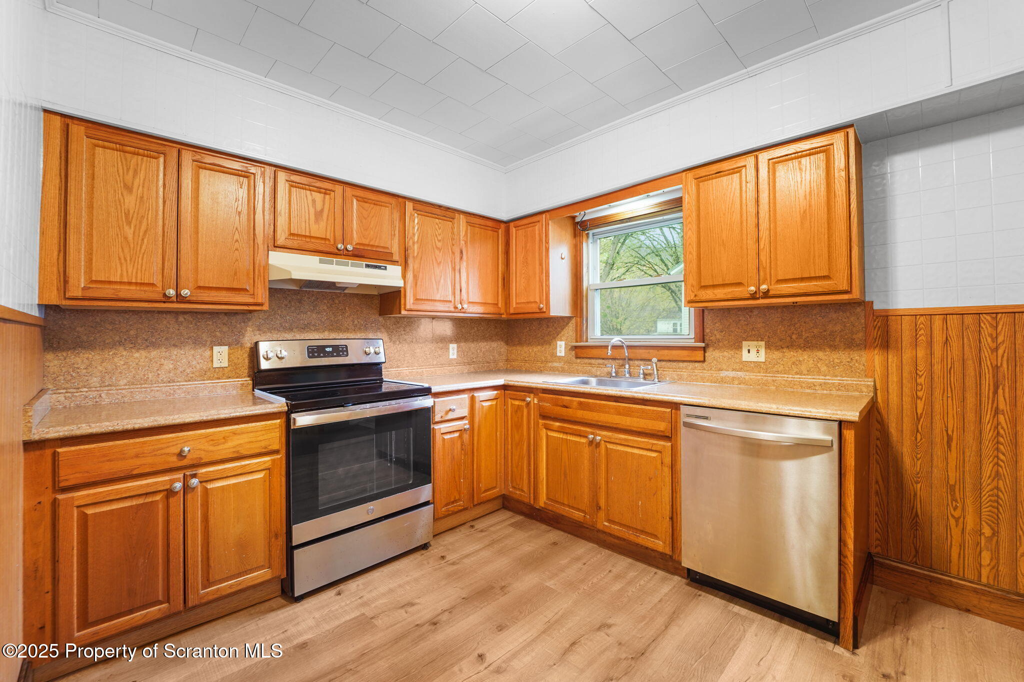 117 Church Road Harford, PA 18823 - Photo 10 of 35 a kitchen with granite countertop wooden floors and stainless steel appliances