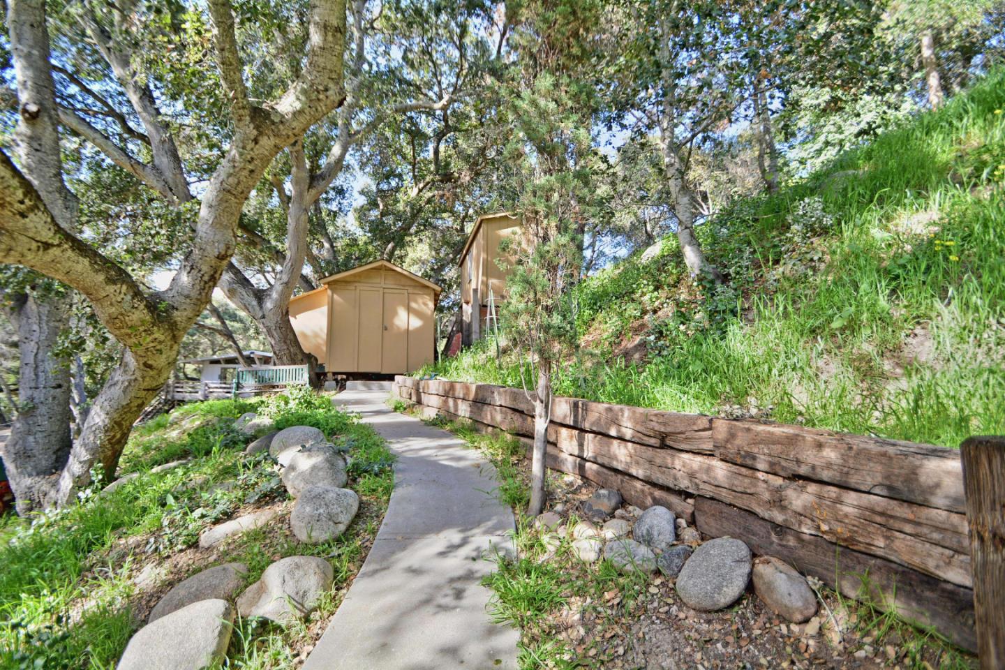 55 Paso Cresta Carmel Valley, CA 93924 - Photo 11 of 26 a backyard of a house with table and chairs