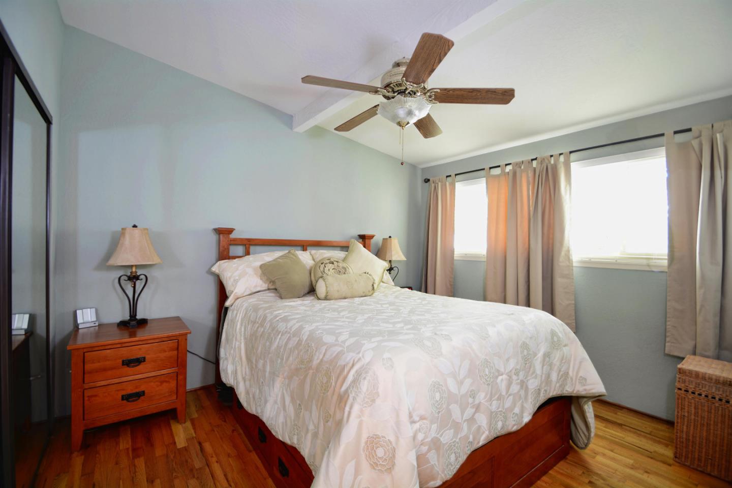 55 Paso Cresta Carmel Valley, CA 93924 - Photo 18 of 26 a bedroom with bed and wooden floor