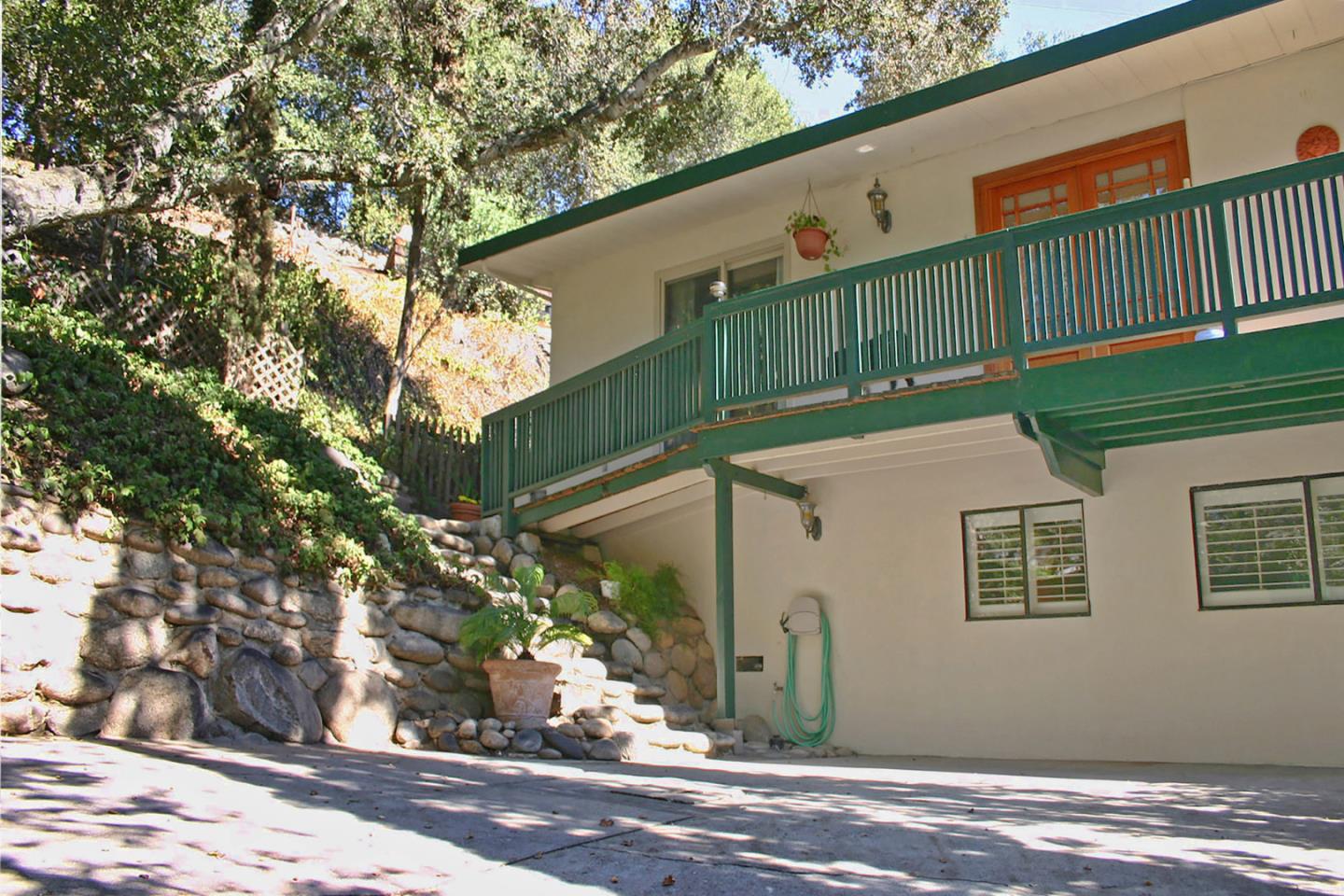 55 Paso Cresta Carmel Valley, CA 93924 - Photo 2 of 26 a front view of a house with a yard