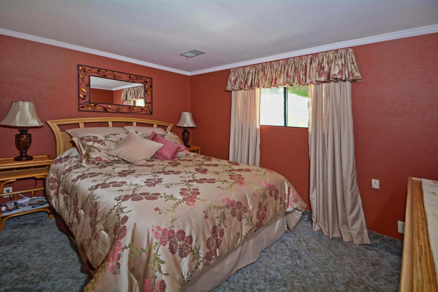55 Paso Cresta Carmel Valley, CA 93924 - Photo 23 of 26 a bedroom with a bed and a window