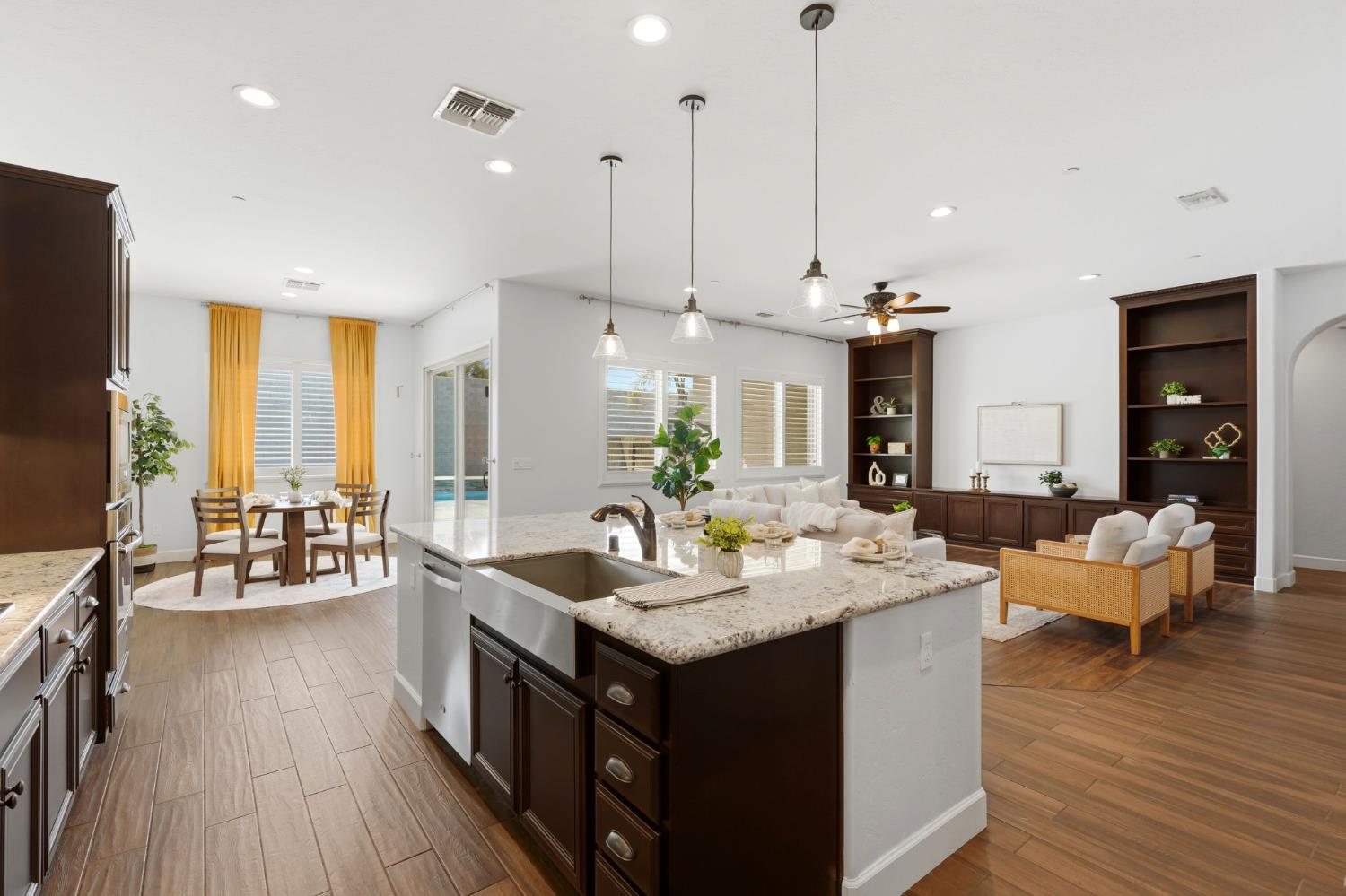 3368 North Discovery Way Hanford, CA 93230 - Photo 15 of 43 a kitchen with center island wooden floor and a view of living room