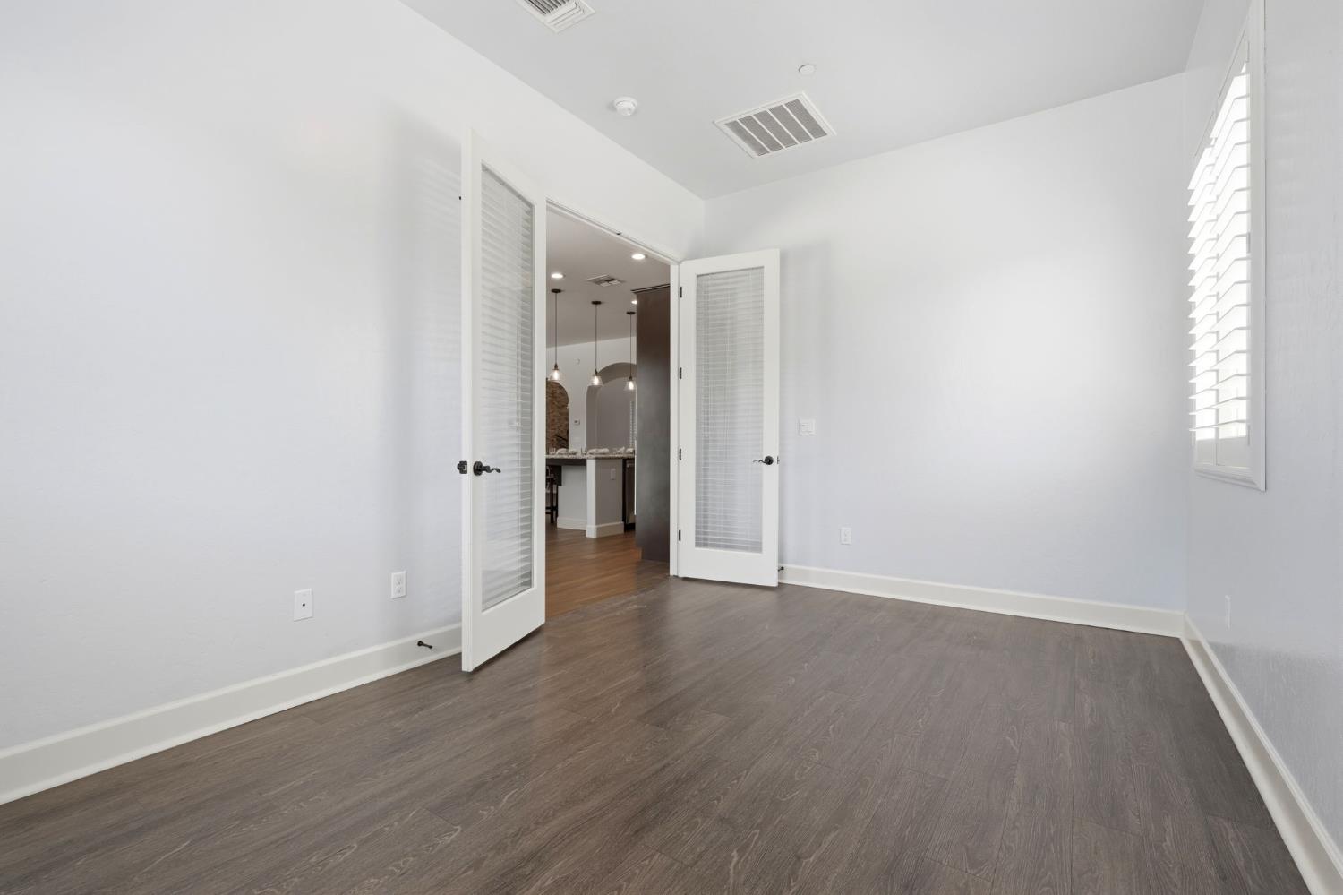 3368 North Discovery Way Hanford, CA 93230 - Photo 19 of 43 an empty room with wooden floor and a window