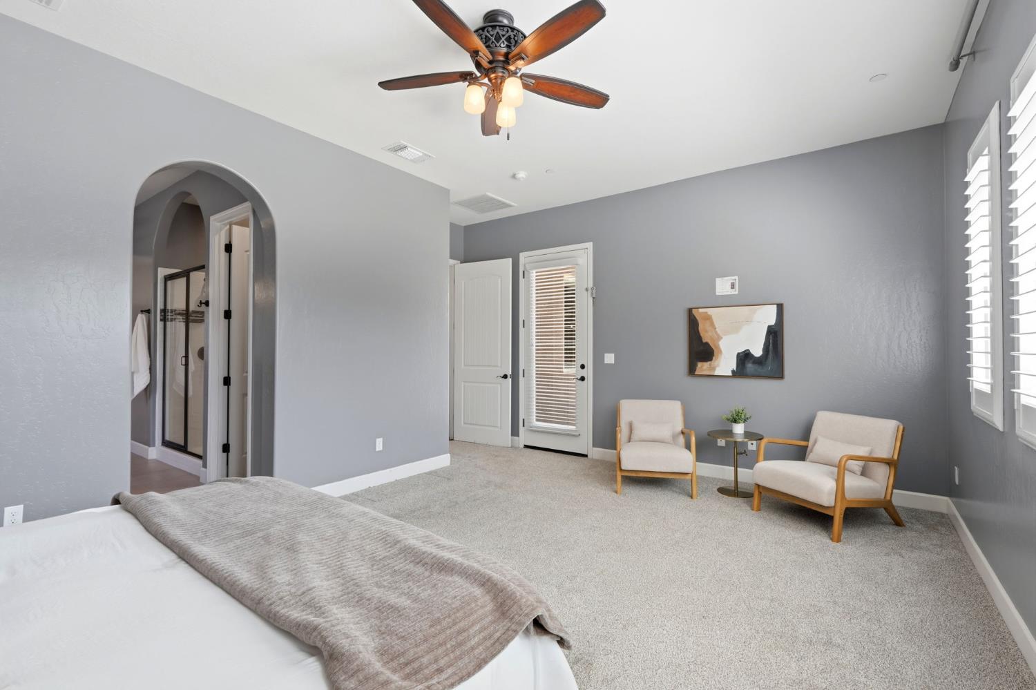 3368 North Discovery Way Hanford, CA 93230 - Photo 23 of 43 a bedroom with a bed and a chandelier