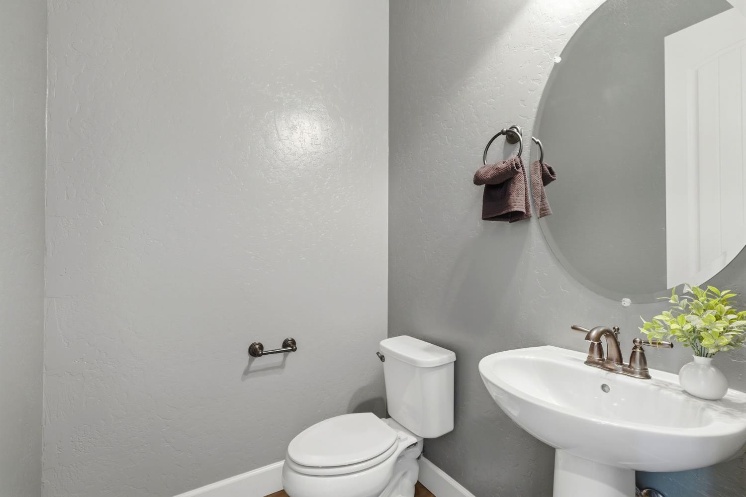 3368 North Discovery Way Hanford, CA 93230 - Photo 34 of 43 a bathroom with a sink a toilet and mirror
