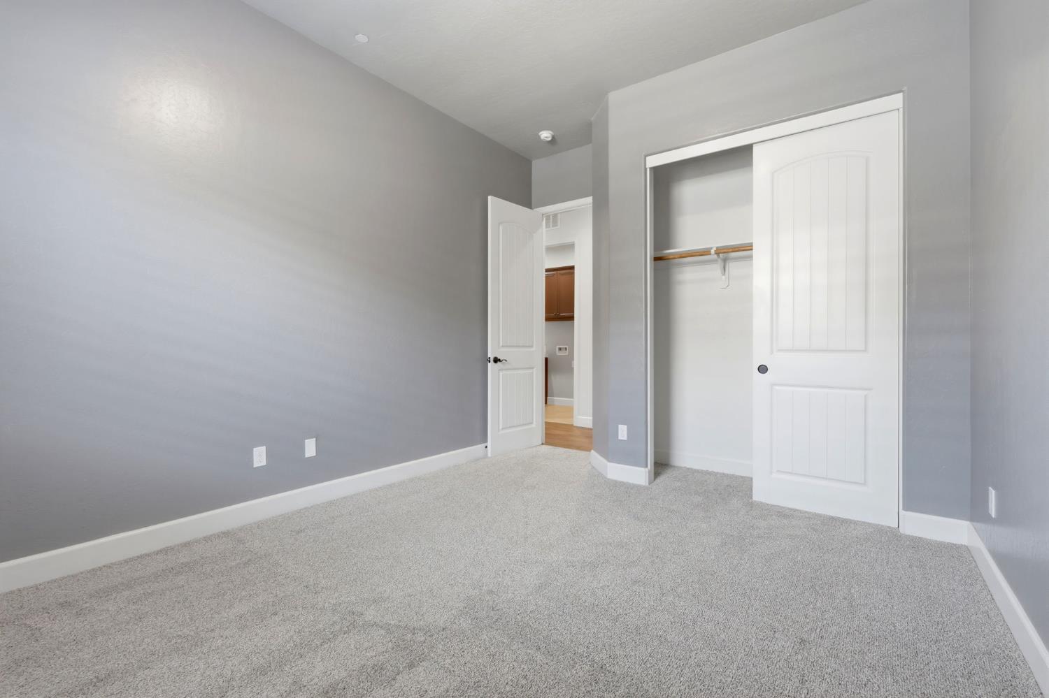 3368 North Discovery Way Hanford, CA 93230 - Photo 36 of 43 an empty room with closet and wooden door