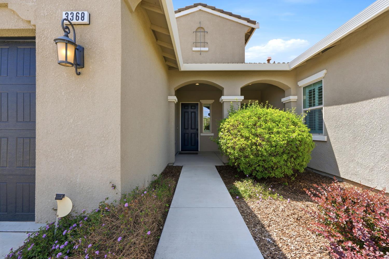 3368 North Discovery Way Hanford, CA 93230 - Photo 4 of 43 a couple of potted plants in front of a door