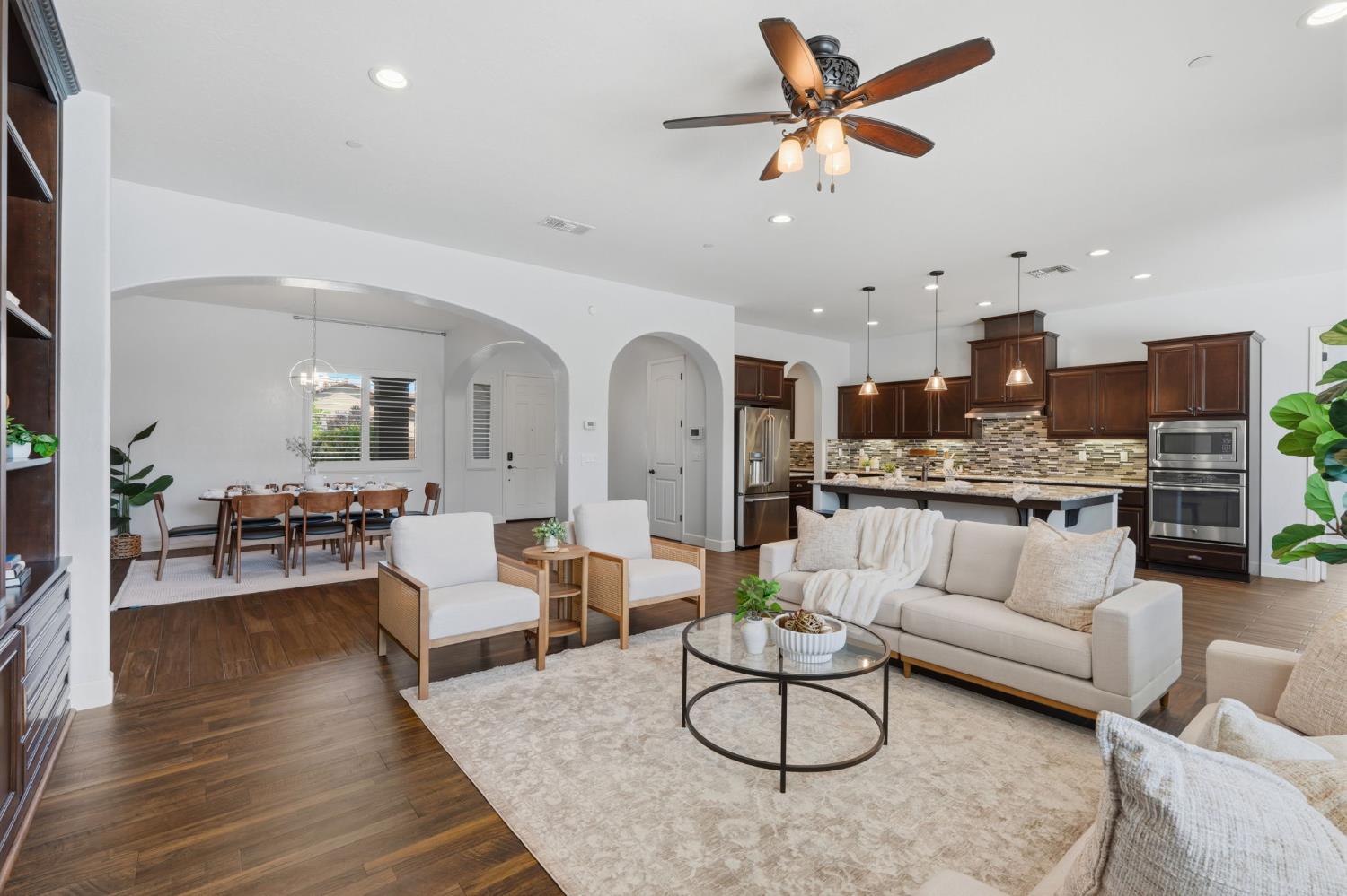 3368 North Discovery Way Hanford, CA 93230 - Photo 9 of 43 a living room with furniture kitchen view and a chandelier