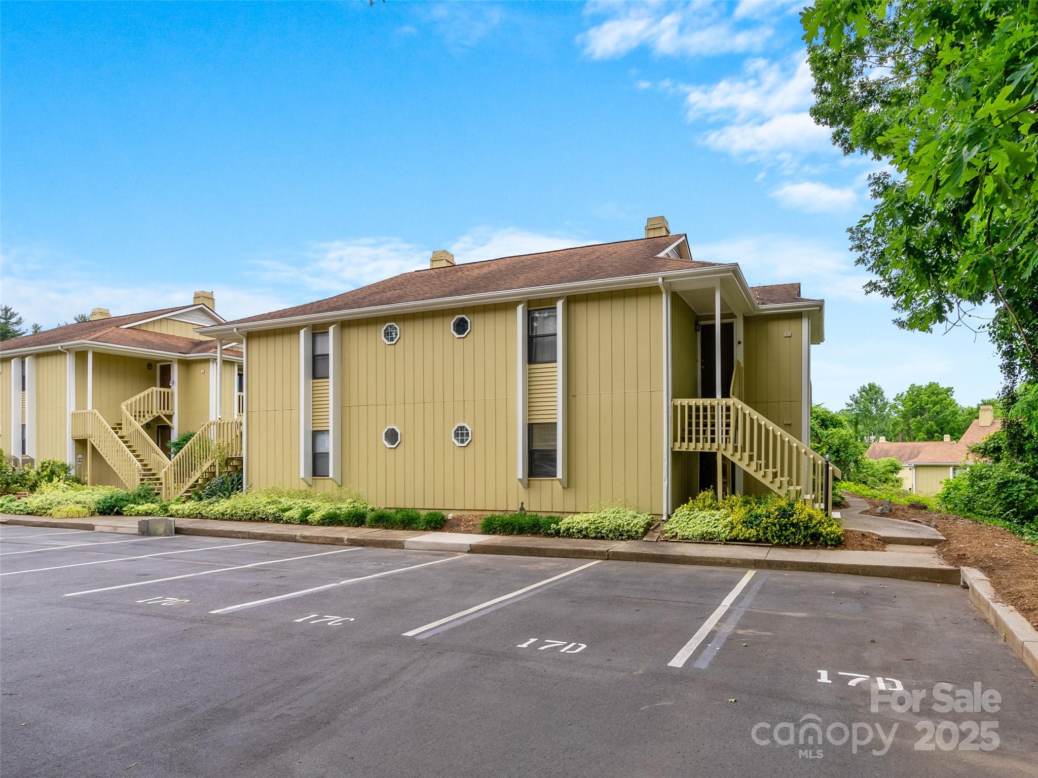 110 Heywood Road, Unit 17C Arden, NC 28704 - Photo 25 of 26 a front view of a house with a yard