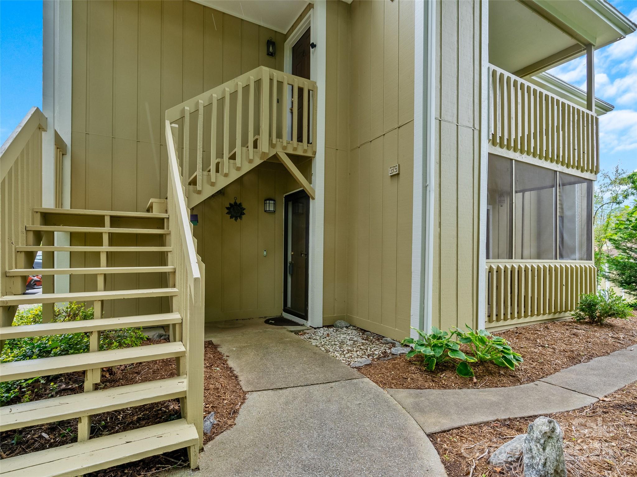 110 Heywood Road, Unit 17C Arden, NC 28704 - Photo 3 of 26 a porch with a bench in front of it
