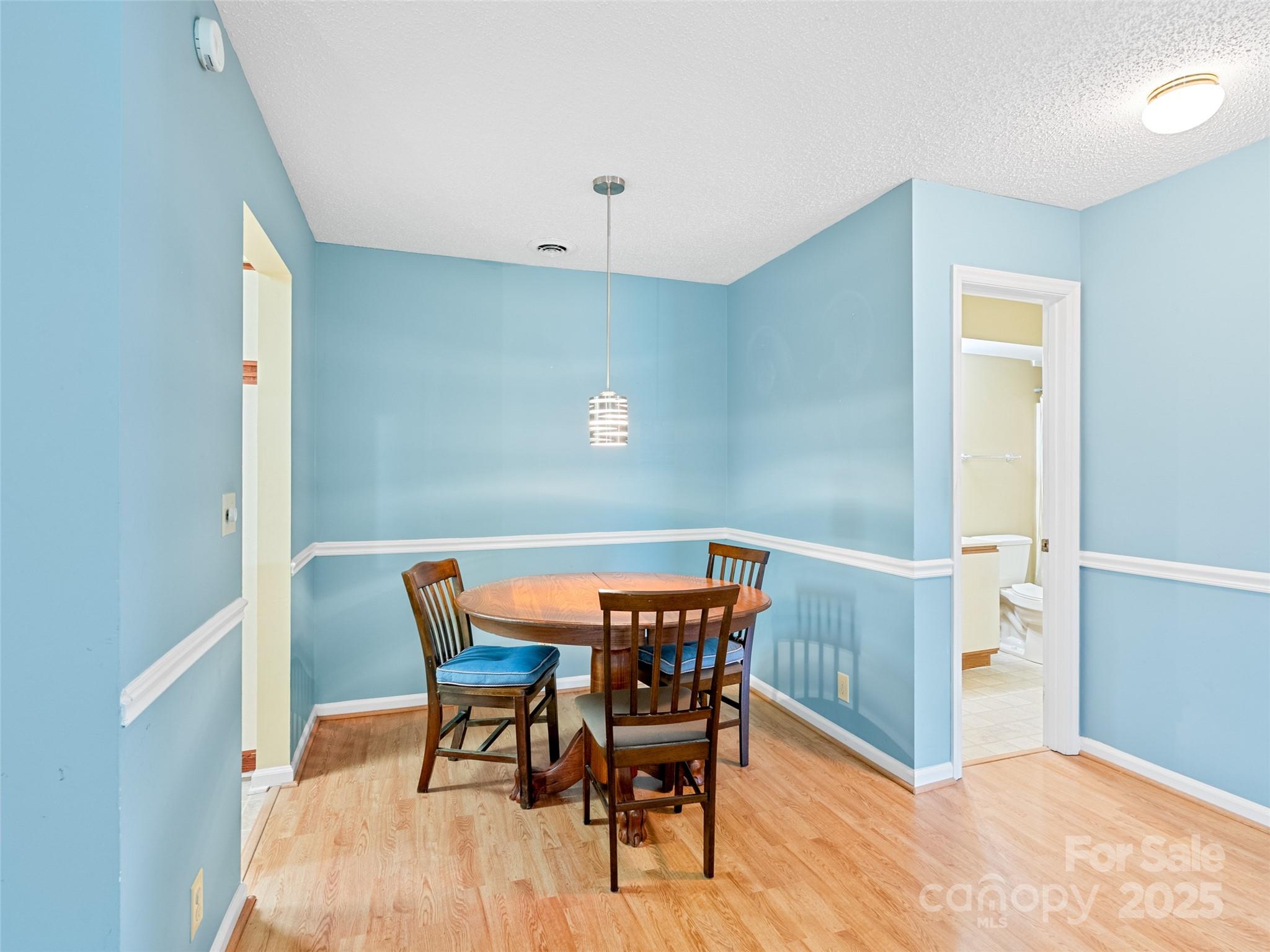 110 Heywood Road, Unit 17C Arden, NC 28704 - Photo 6 of 26 a view of a dining room with furniture and wooden floor