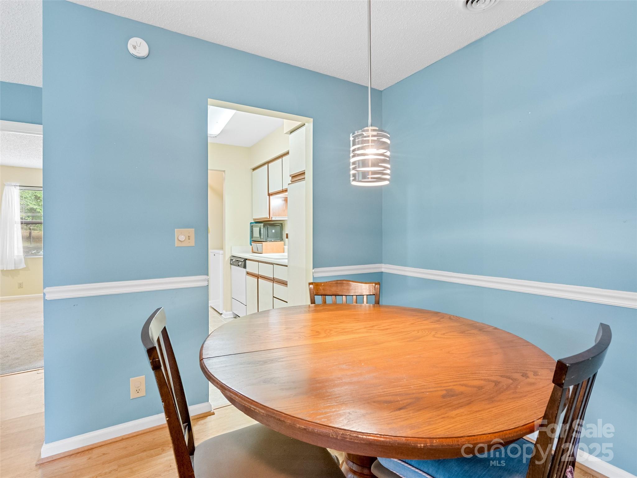 110 Heywood Road, Unit 17C Arden, NC 28704 - Photo 7 of 26 a view of a dining room with furniture and wooden floor