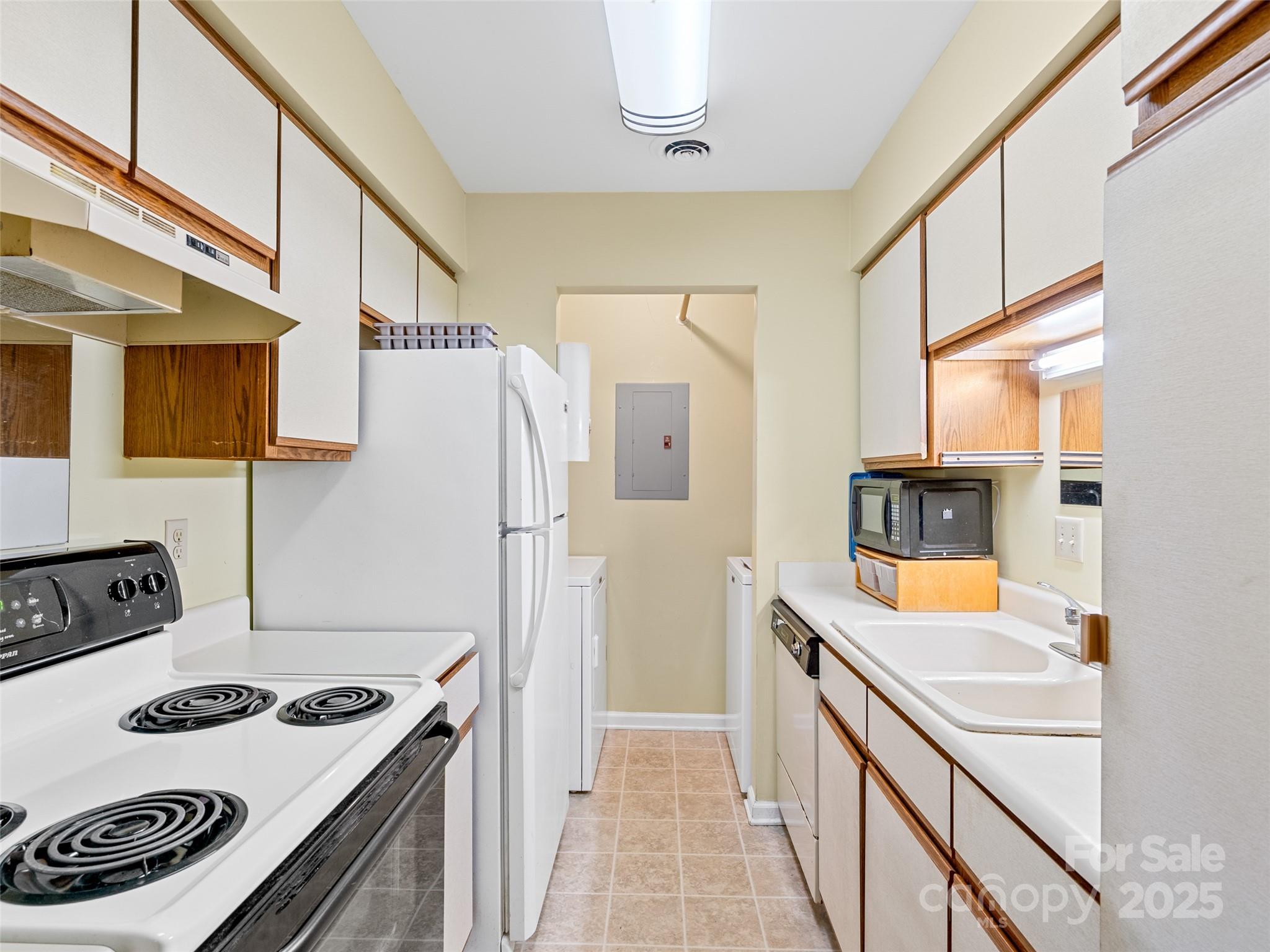 110 Heywood Road, Unit 17C Arden, NC 28704 - Photo 8 of 26 a kitchen with stainless steel appliances granite countertop a sink and a stove
