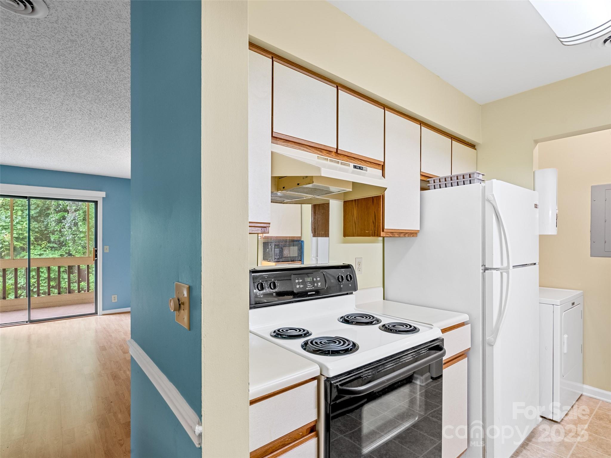 110 Heywood Road, Unit 17C Arden, NC 28704 - Photo 9 of 26 a kitchen with a stove and a refrigerator