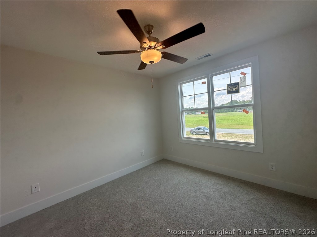 8383 Shannon Road Shannon, NC 28386 - Photo 12 of 17 an empty room with windows and ceiling fan