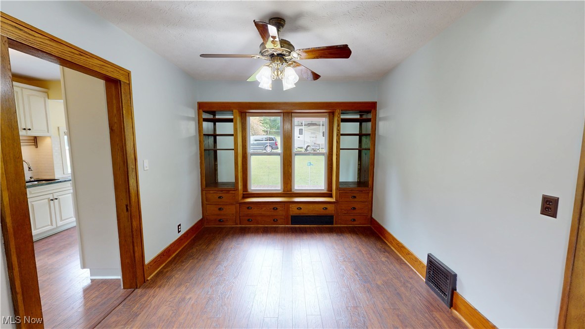 3261 Darrow Road Stow, OH 44224 - Photo 8 of 27 Spare room with dark wood finished floors, baseboards, ceiling fan, and a sink