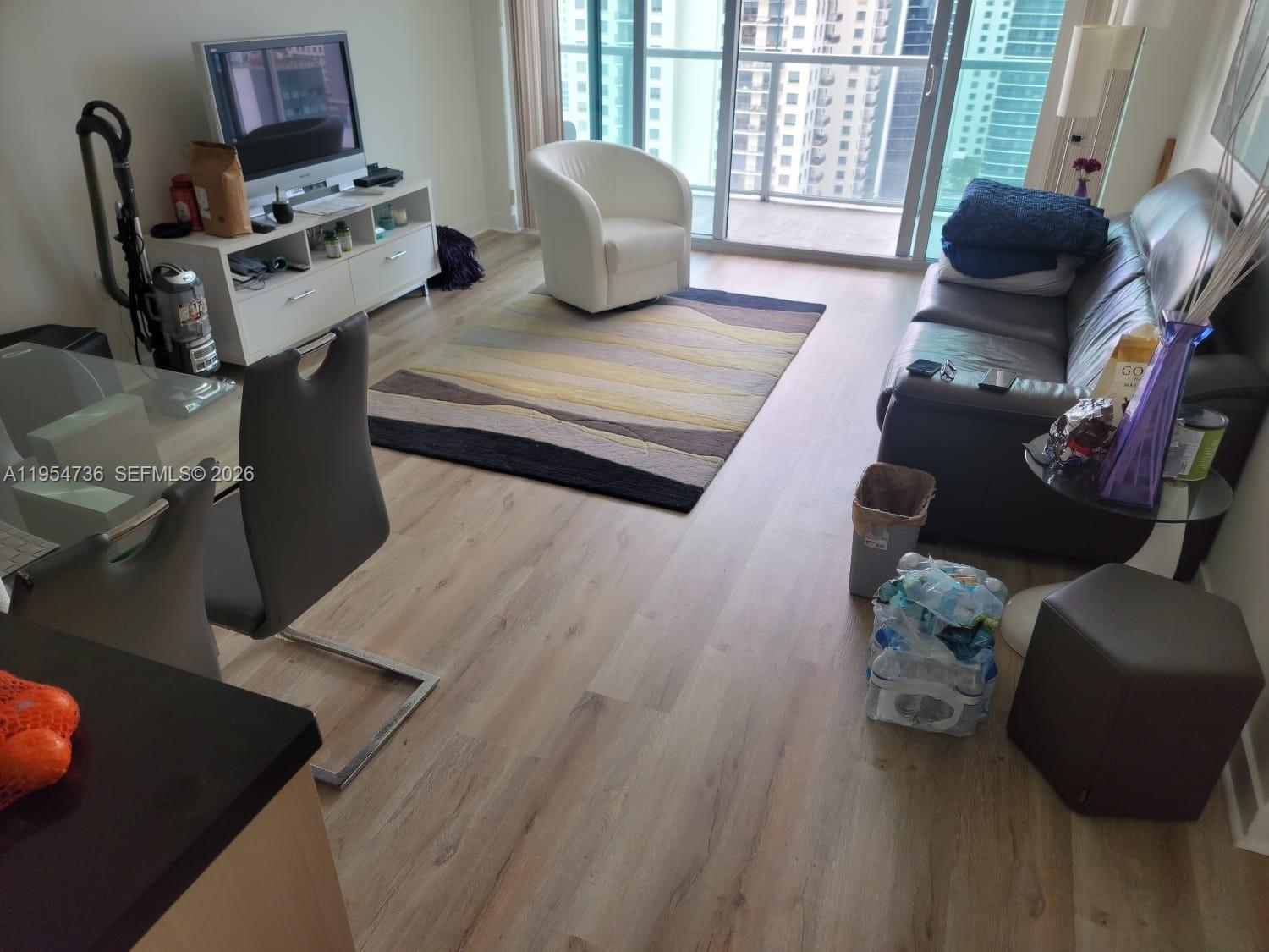 1111 Southwest 1st Avenue, Unit 3022N Miami, FL 33130 - Photo 2 of 14 a living room with furniture and a window