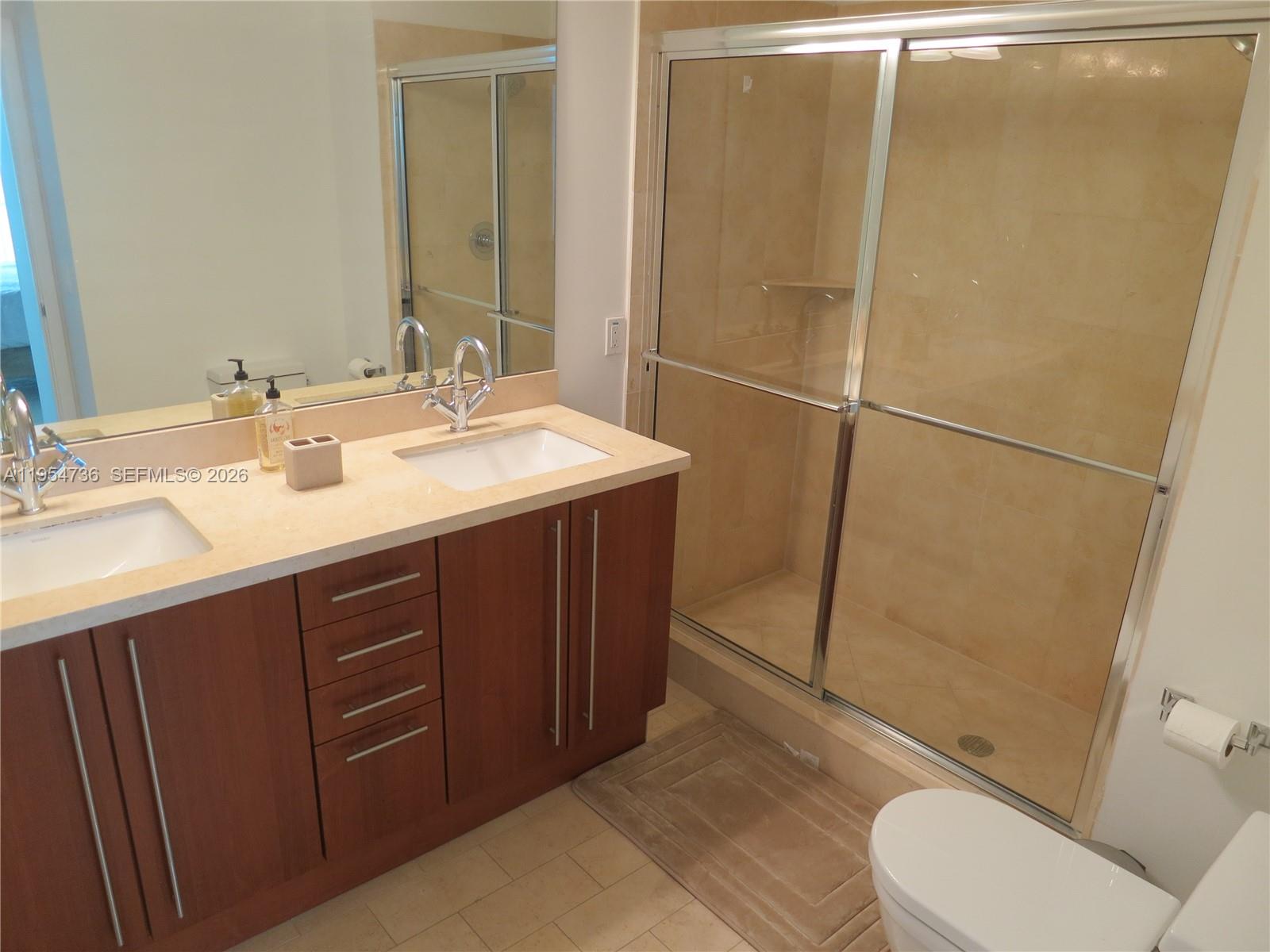 1111 Southwest 1st Avenue, Unit 3022N Miami, FL 33130 - Photo 5 of 14 a bathroom with a sink toilet and shower