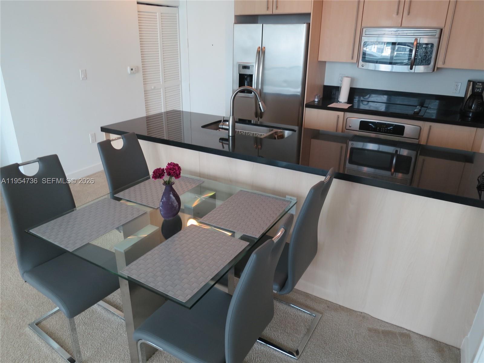 1111 Southwest 1st Avenue, Unit 3022N Miami, FL 33130 - Photo 7 of 14 a view of a dining room with furniture