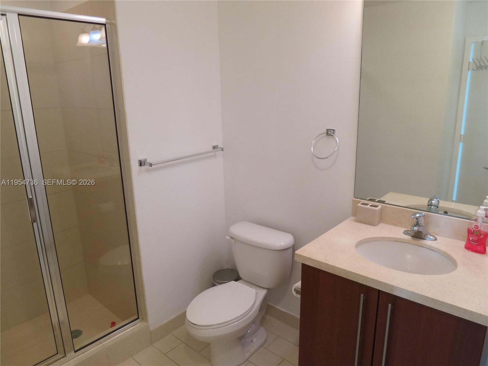 1111 Southwest 1st Avenue, Unit 3022N Miami, FL 33130 - Photo 9 of 14 a bathroom with a sink toilet and shower