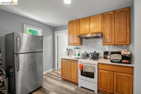 a kitchen with stainless steel appliances a refrigerator sink and cabinets