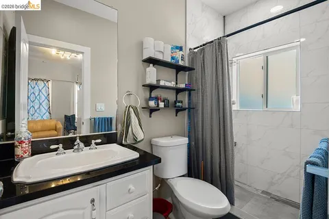 a bathroom with a sink toilet vanity and shower