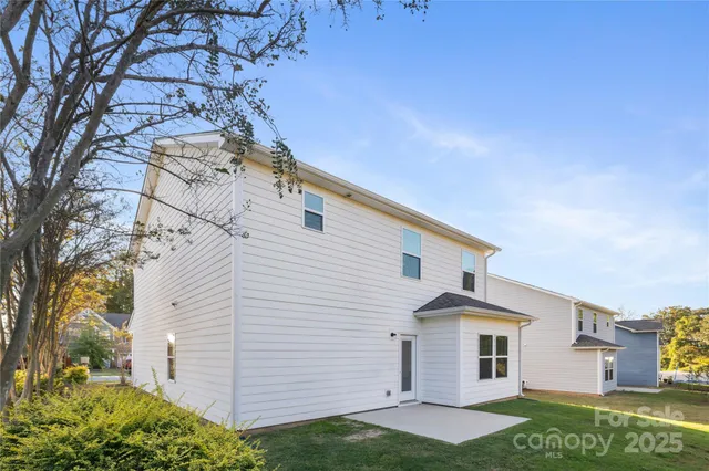a view of a white house with a yard