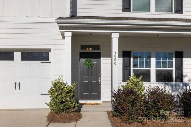 front view of a house with potted plants