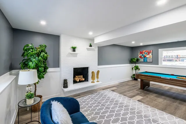 a room with pool table and windows