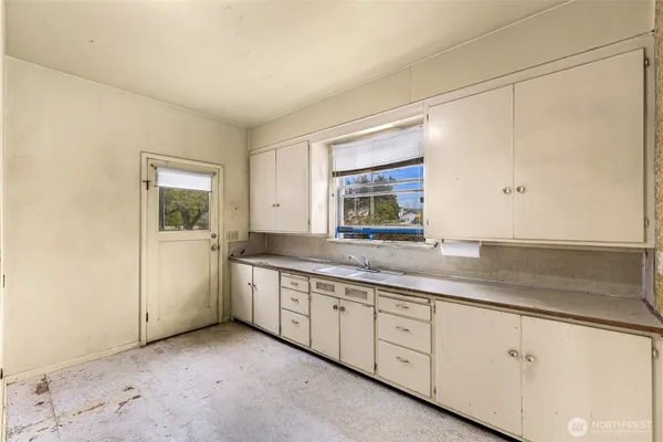 a kitchen with sink and cabinets