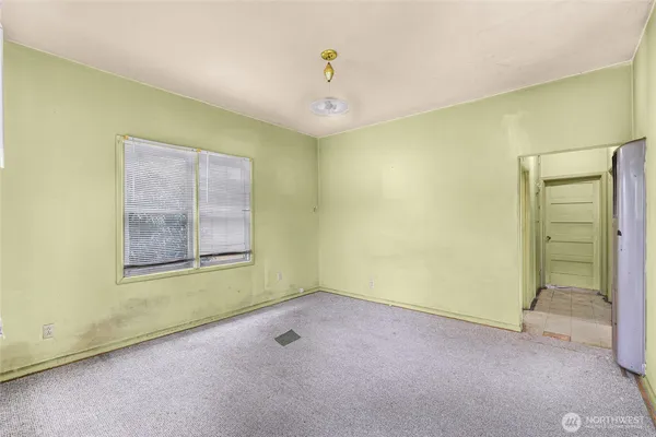 an empty room with windows and closet