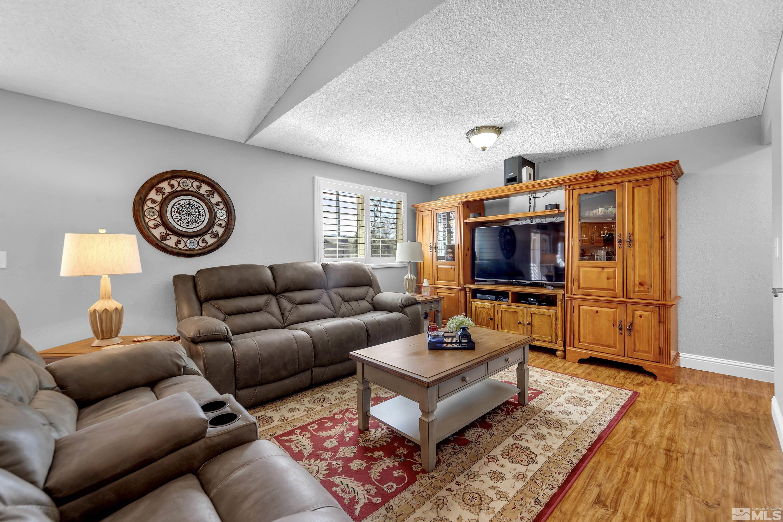 4900 Spring Drive Reno, NV 89502 - Photo 15 of 34 a living room with furniture a rug and a flat screen tv