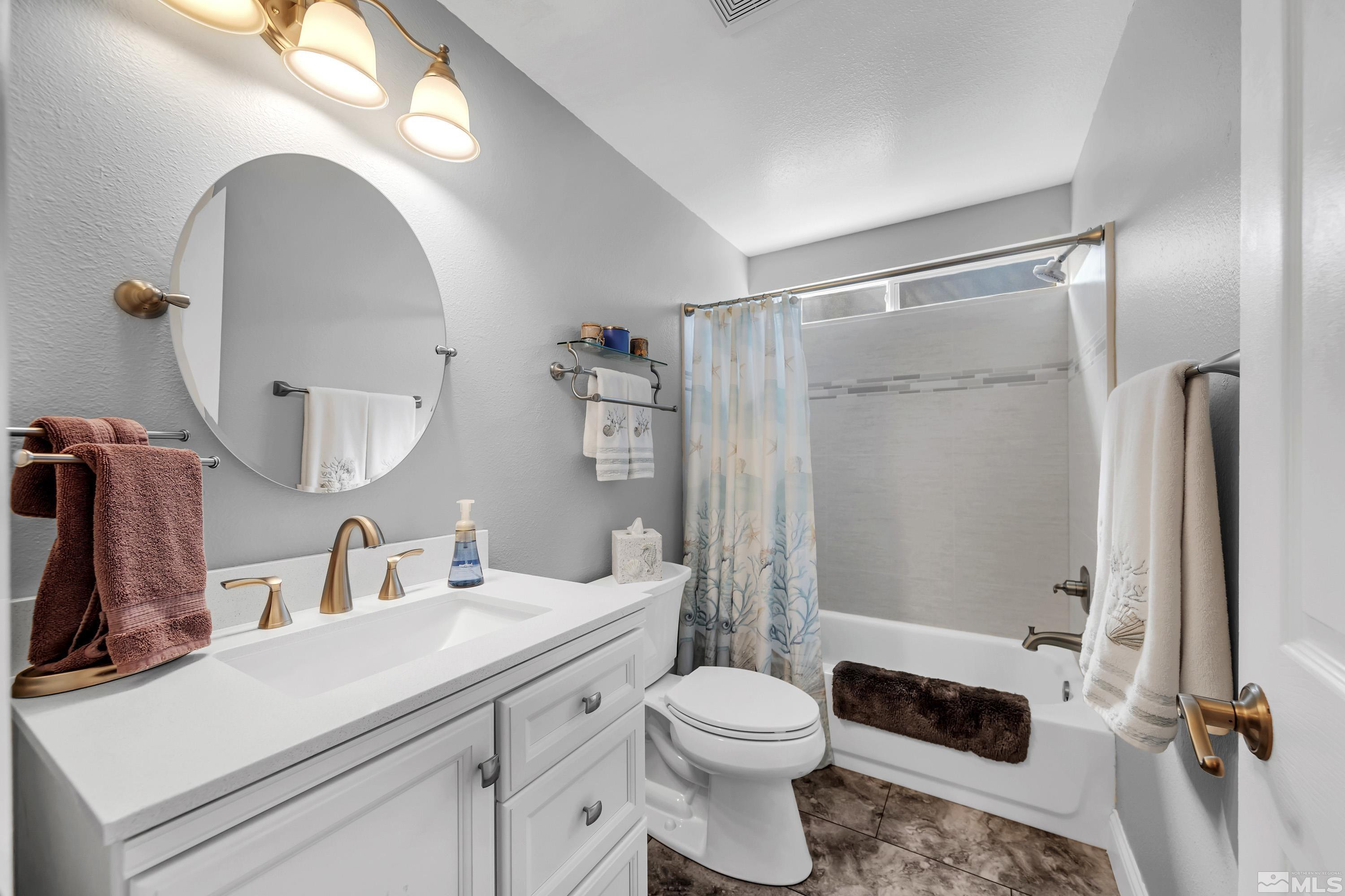 4900 Spring Drive Reno, NV 89502 - Photo 28 of 34 a bathroom with a sink a toilet a mirror and shower