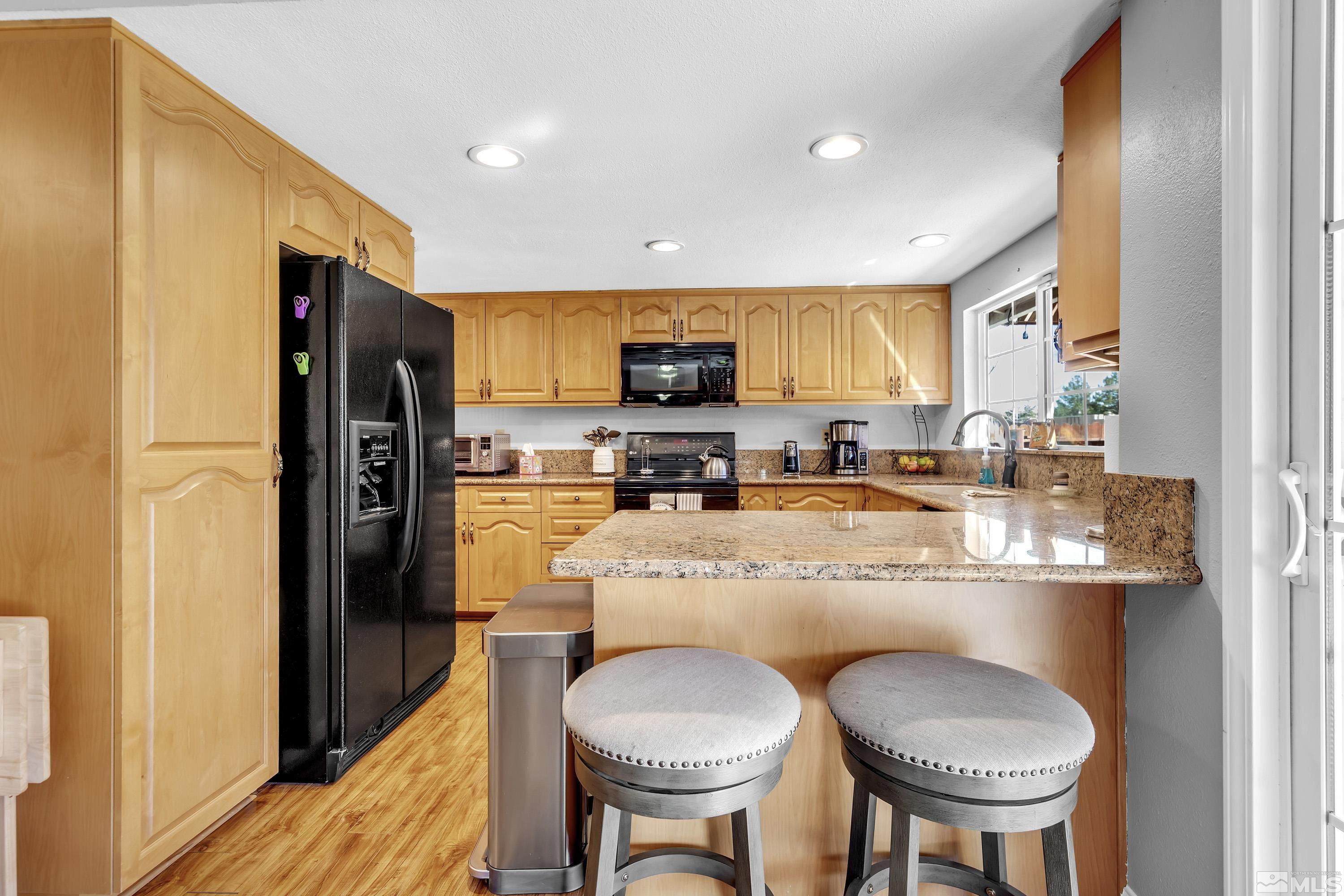 4900 Spring Drive Reno, NV 89502 - Photo 9 of 34 a kitchen with stainless steel appliances a stove a refrigerator and a dining table