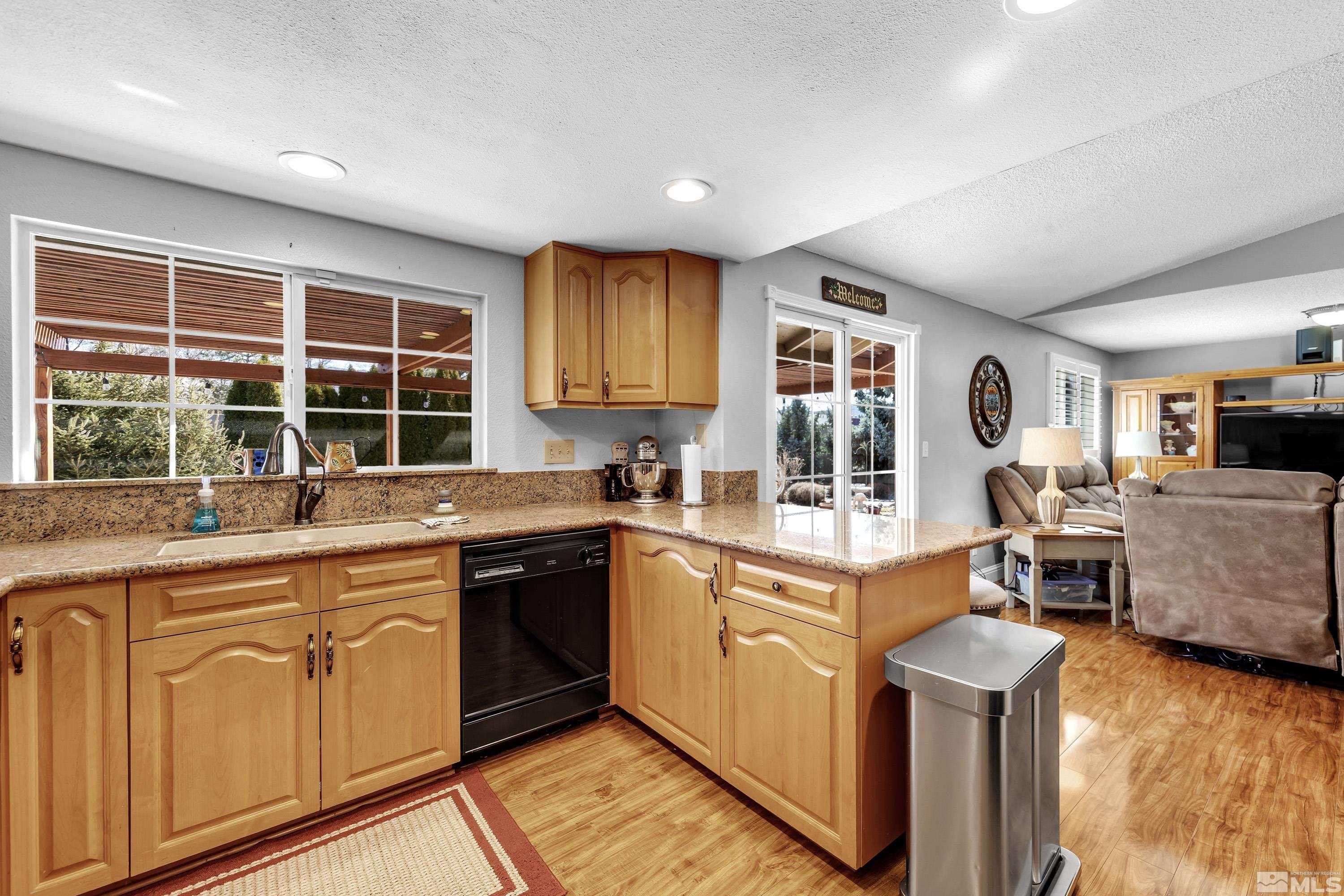 4900 Spring Drive Reno, NV 89502 - Photo 10 of 34 a open kitchen with granite countertop a sink and white cabinets