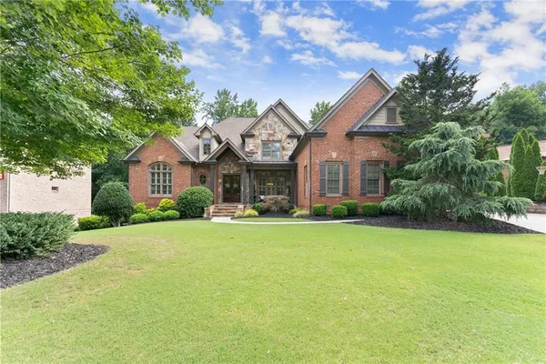 a front view of a house with a garden