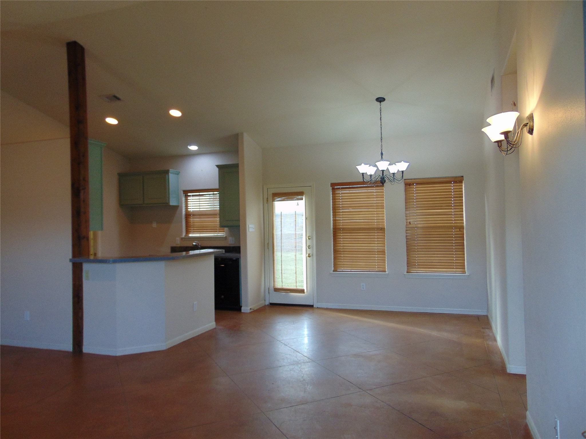 a view of livingroom and kitchen with chandelier