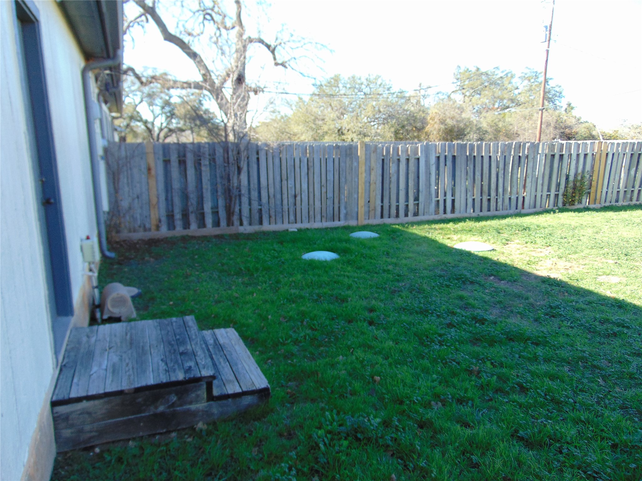 100 Chestnut Ridge, Unit A Dripping Springs, TX 78620 - Photo 14 of 14 a view of backyard with wooden fence