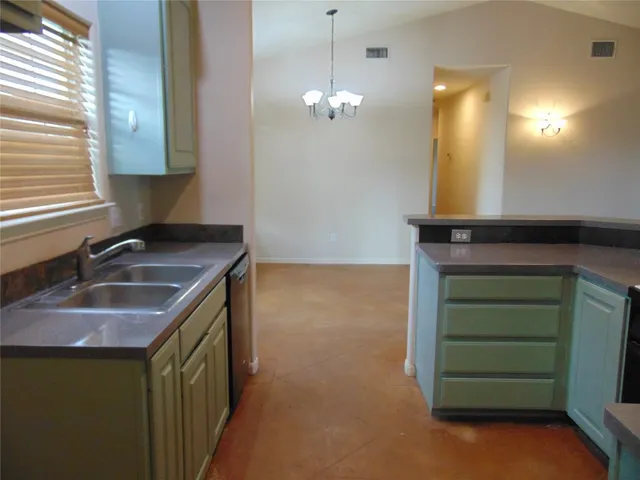 a kitchen with a sink and a mirror