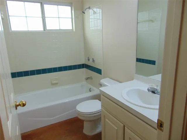 a bathroom with a sink a toilet and bathtub