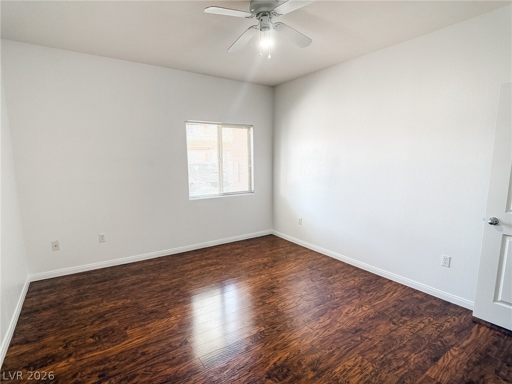 7701 West Robindale Road, Unit 110 Las Vegas, NV 89113 - Photo 12 of 21 Rich hardwood floors complement this bright, inviting bedroom.