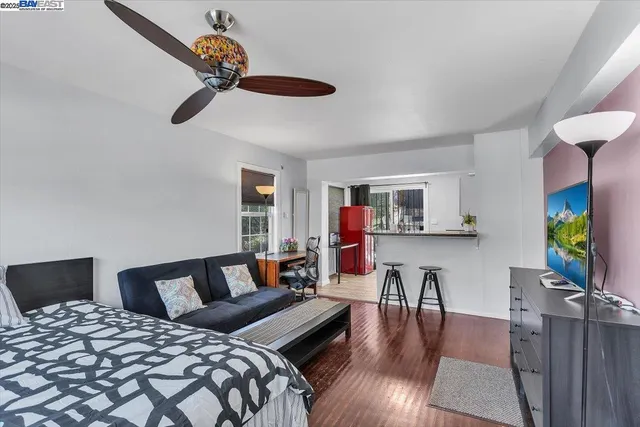 a bedroom with furniture and a wooden floor