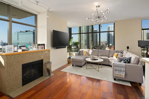 a living room with furniture a fireplace and a flat screen tv