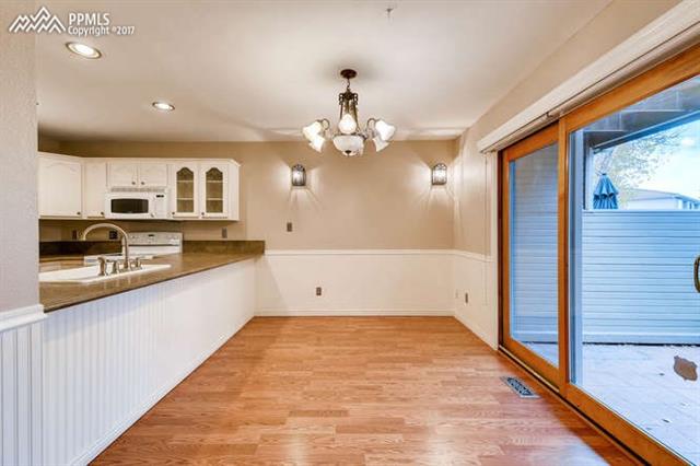 67 Rising Sun Terrace Colorado Springs, CO 80921 - Photo 11 of 26 Kitchen / Dining area exits to outdoor patio with small yard