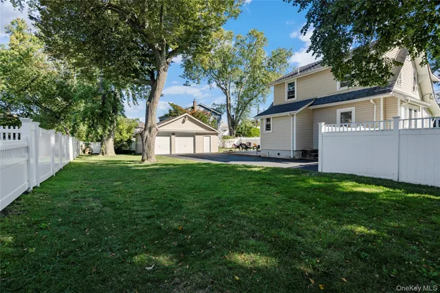 a view of a backyard with table and chairs and a fire pit
