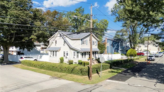 a front view of a house with a yard table and chairs
